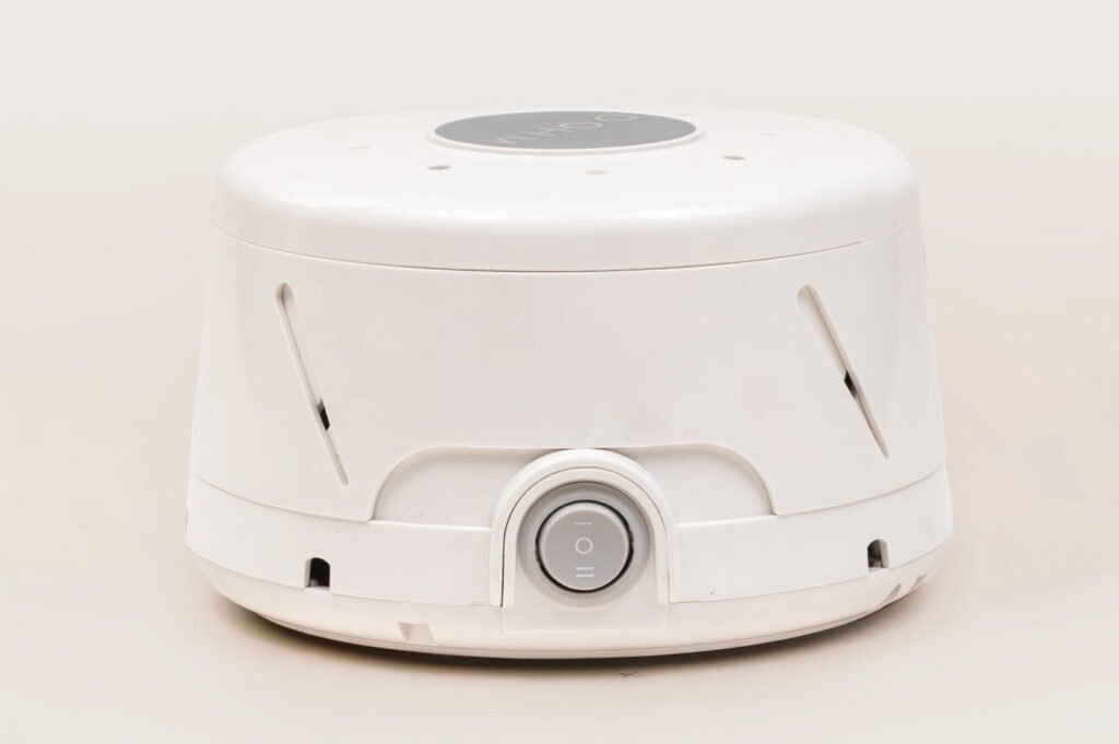 A white, circular-shaped sound machine