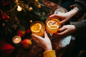 The Hands of Two People with Their Holiday Cocktails